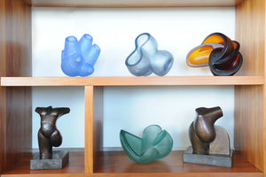 Cast glass and bronze sculptures on shelves. Stephen Williams