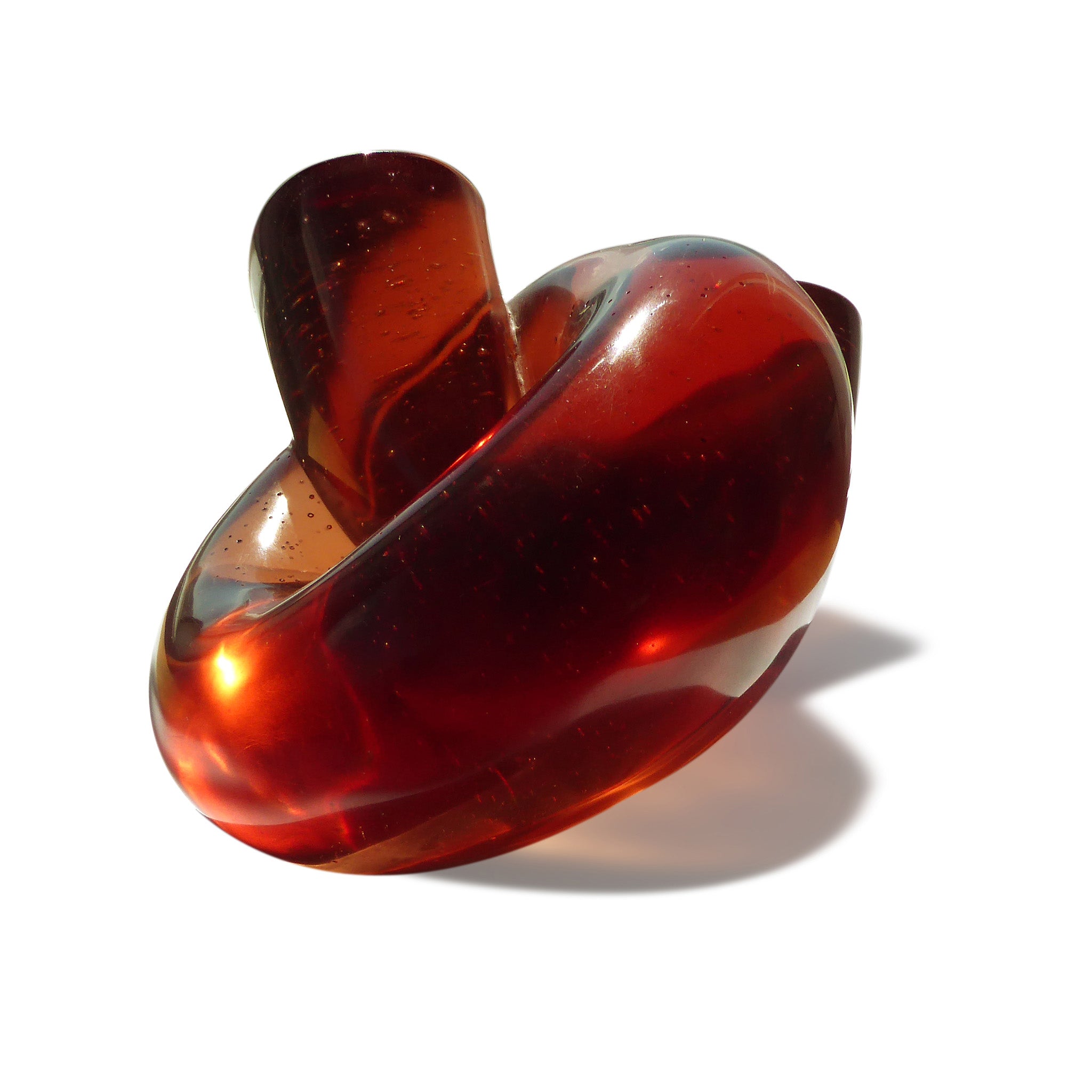 Abstract polished cast glass sculpture of red blood cells by Stephen Williams.